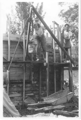 Handing off cement on the scaffolding