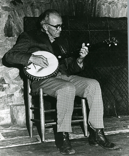 J Roy Stalcup plays his banjo in Keith House.