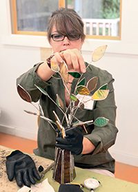 A student creates an open work glass piece in Karen's class at the Folk School