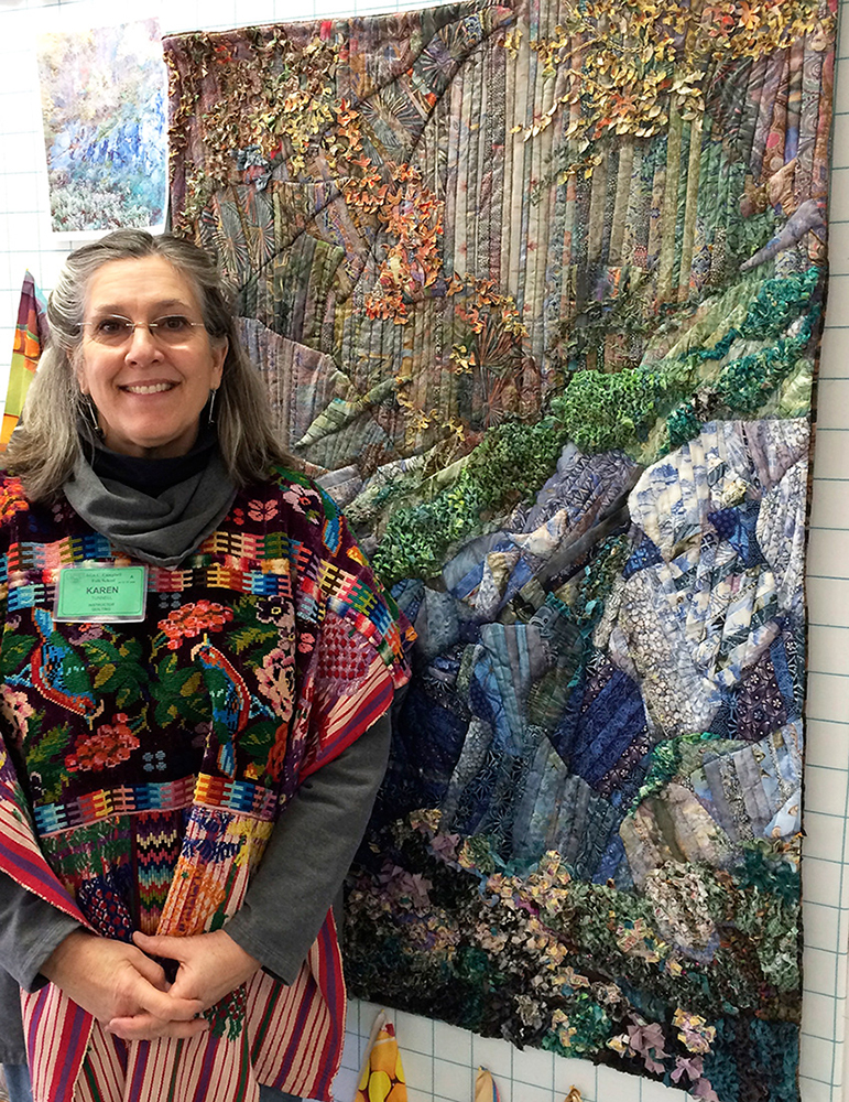 Instructor Karen Tunnell in front of one of her Quilted Landscapes.