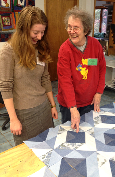 Audrey teaches Sara about quilt design in the Folk School Quilting Studio.