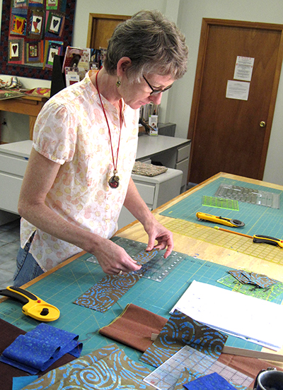 A Student cuts the fabric pieces in Audrey's class