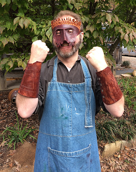 Ivan wears his mask and gauntlet cuffs created in Leatherworking class.