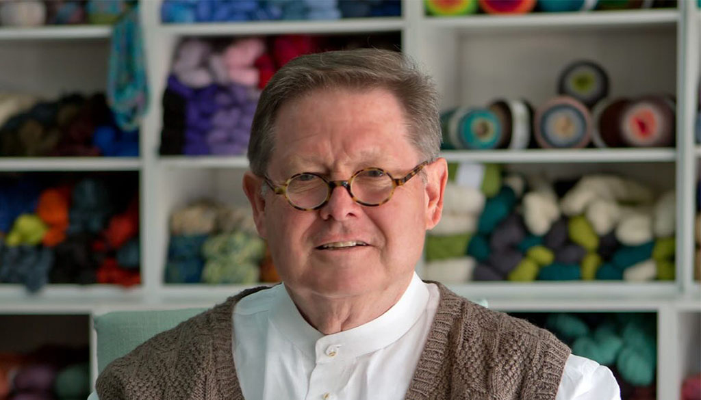 We are lucky to have TKGA Master Knitter Charles D. Gandy teach regularly at the Folk School. I sat down with him in the Wet Room Studio during a class where students were working on fantastic knitted pieces like vegetable gardens, jonquils, and Pop Art-esque Campbell’s soup cans. Charles learned to knit at the young age of four from his mother, a designer and shop owner. He designed his first sweater three years later and continues to create today. Let’s find out a little bit more about Charles D. Gandy.