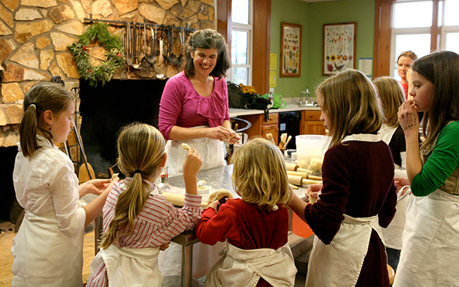 Children make cookies for the Holiday Kids Party