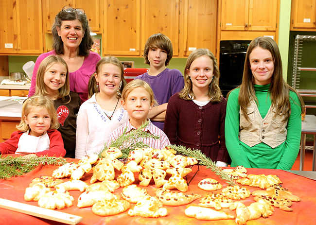 Children make cookies for the Holiday Kids Party