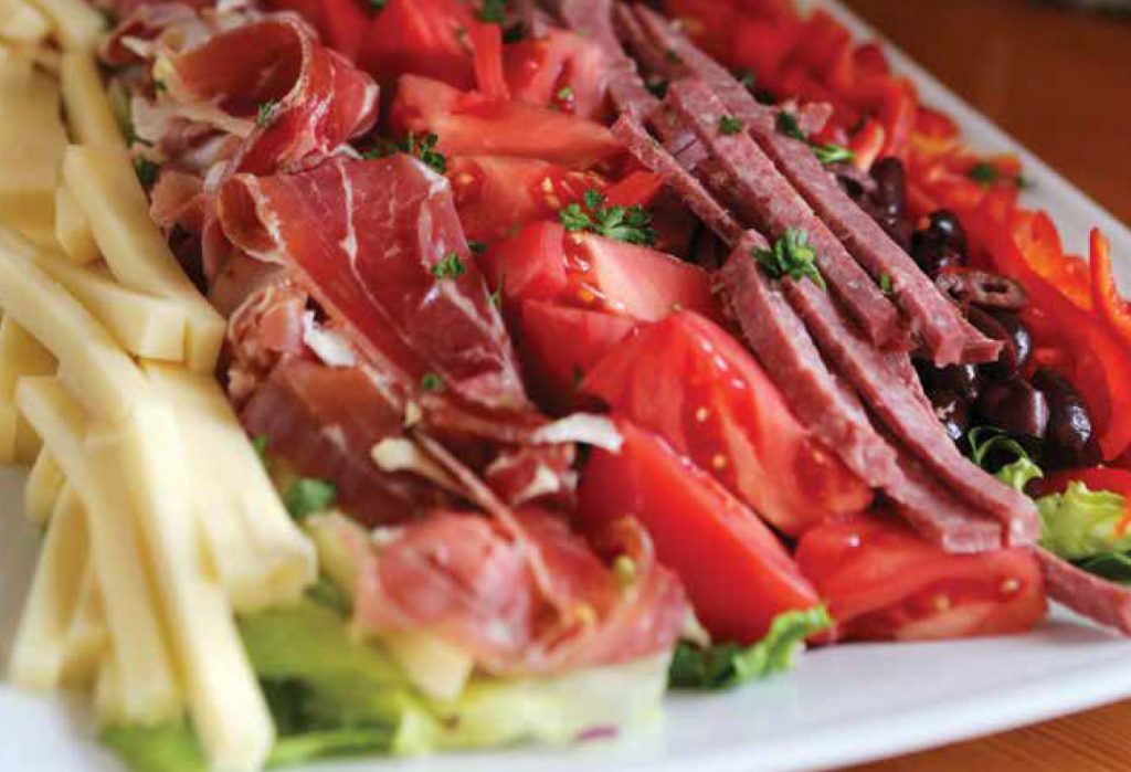 Today we’re sharing the perfect recipe for holiday potlucks. Antipasto Salad is easy to assemble and makes an impressive addition to any table.