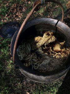 Outside the Wet Room, yarn and cotton wait to develop color in the cauldron