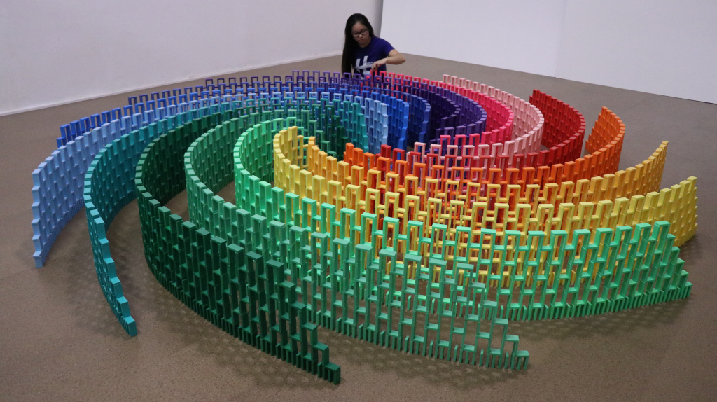 Lily creating a rainbow domino swirl