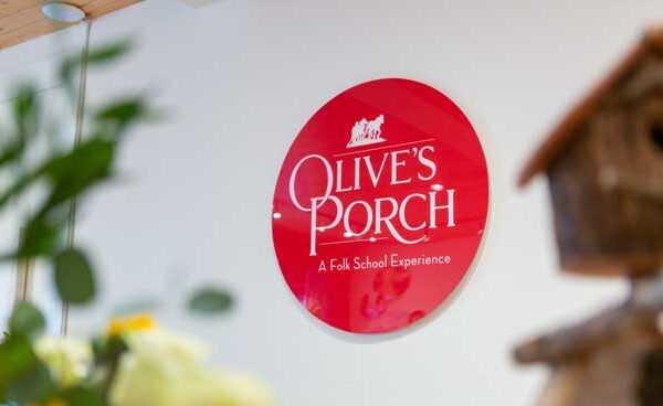 Olive's Porch sign displayed on the wall