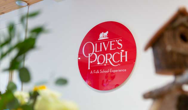 Olive's Porch sign displayed on the wall