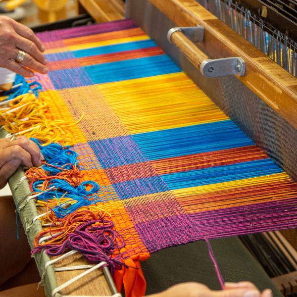 A vibrant rag rug in progress