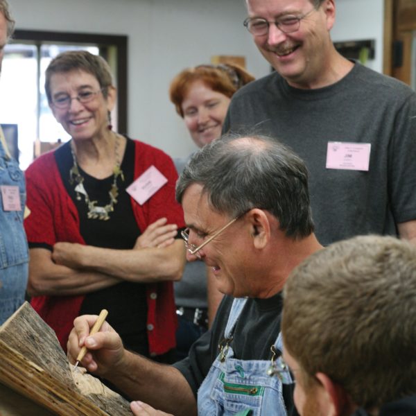 Carving a face into wood