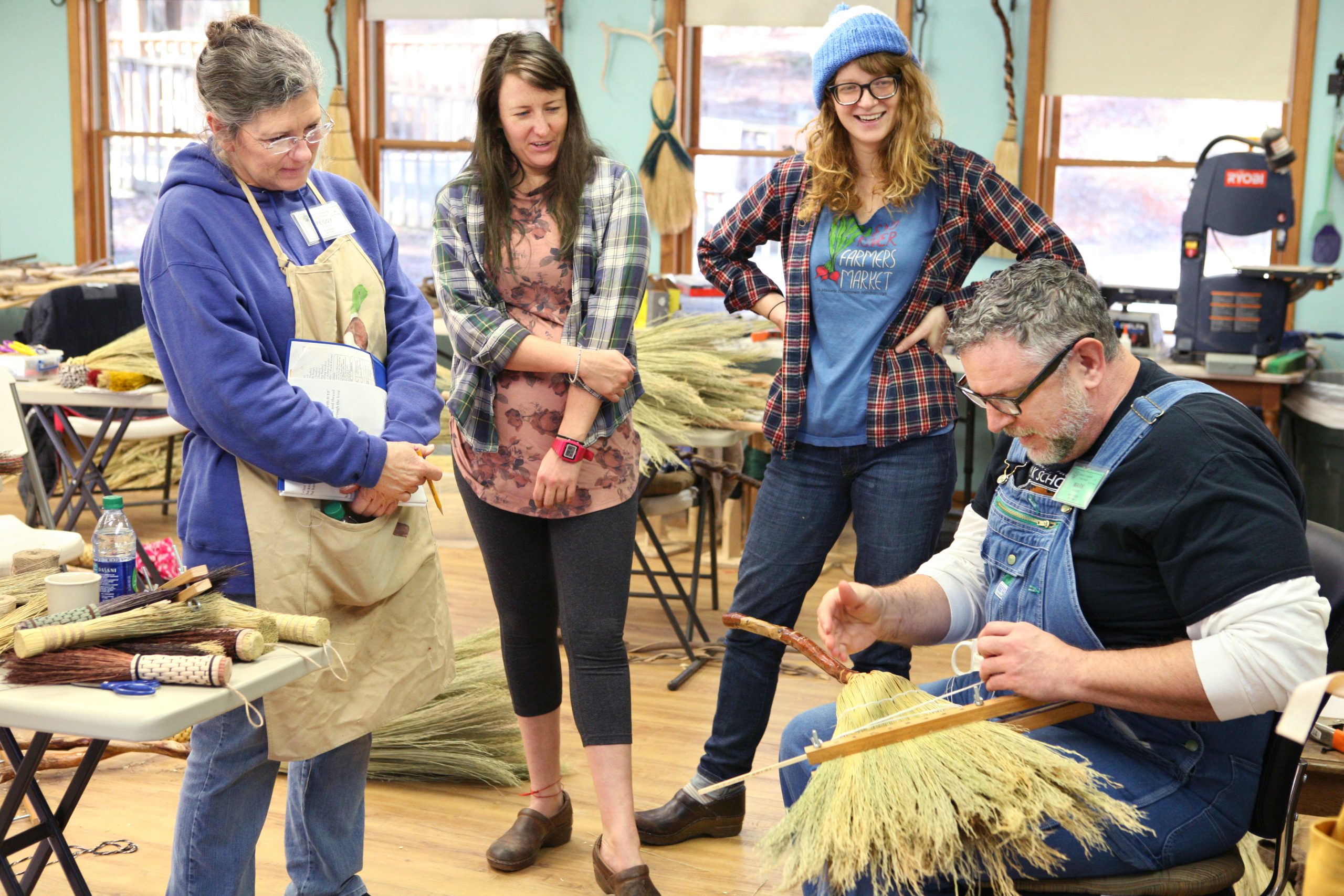 Students learning to piece together a broom