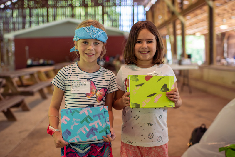 Two Little Middle students showing off their books