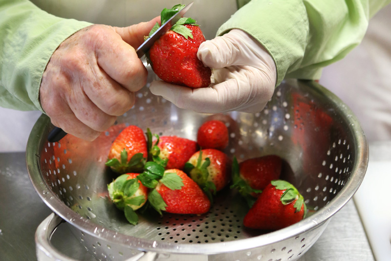 Preparing strawberries for desert