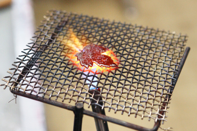 Making the enameled leaf glow with the torch