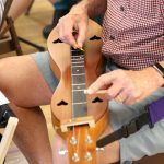 Image of man playing the Dulcimer