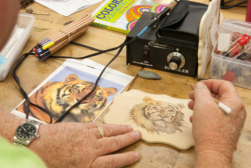 Image of a man woodturning a tiger