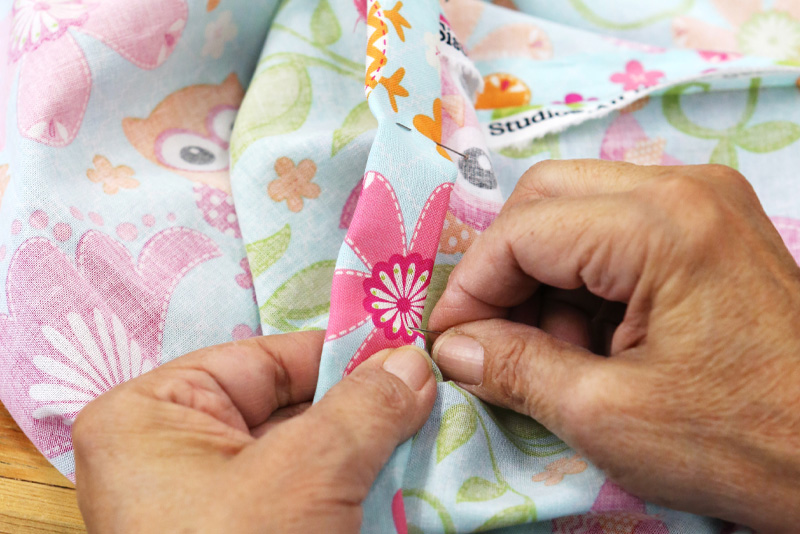 A woman sewing a dress