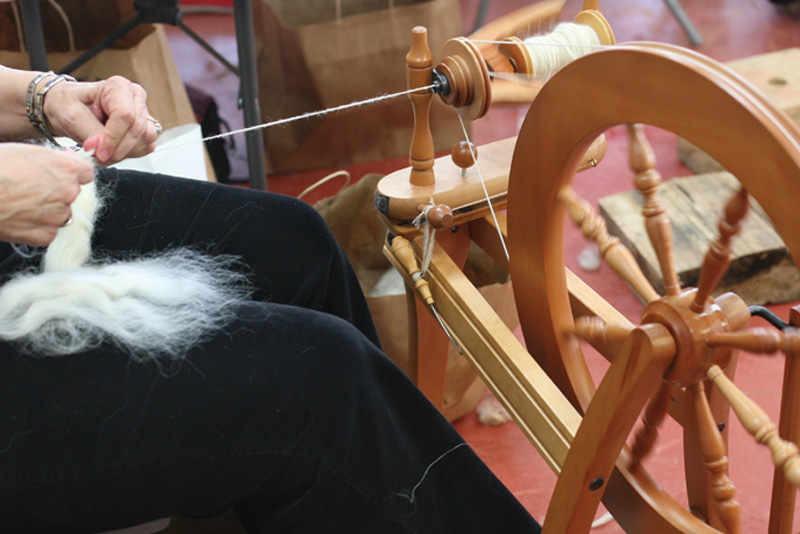 A woman learning to spin