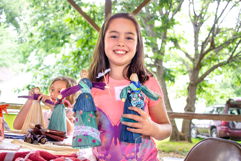 Children making dolls at little middle