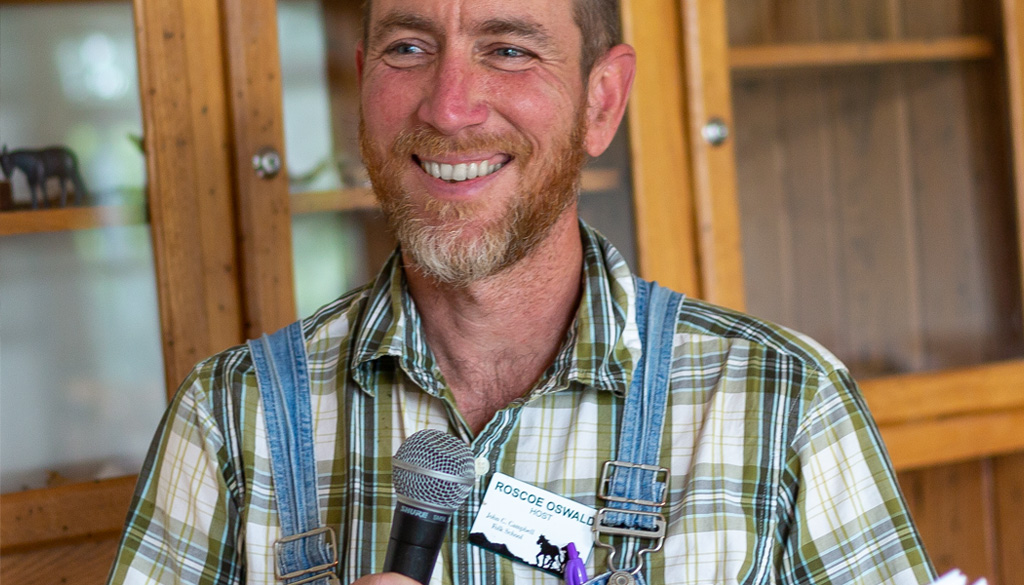 A Student Host making announcements in the Dining Hall