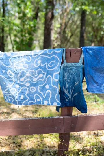 Indigo dyed pieces hanging outside to dry