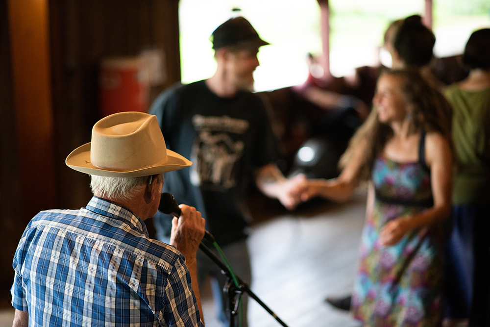 Mack Samples calls a square dance in Open House.