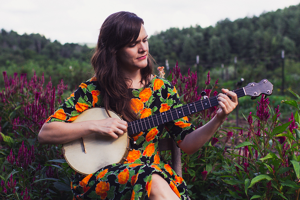 Becky Hill plays banjo in the garden at the John C. Campbell Folk School.