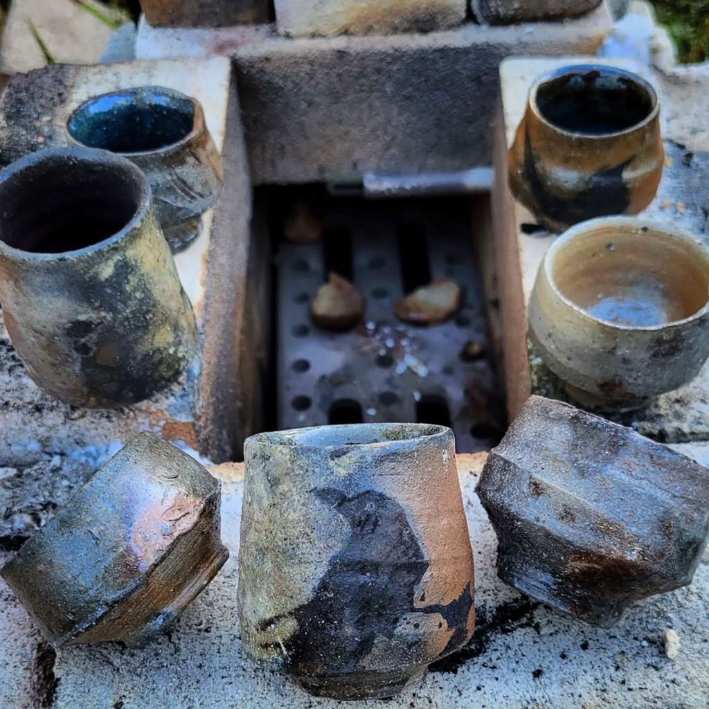 A variety of cups next to a micro atmospheric test kiln
