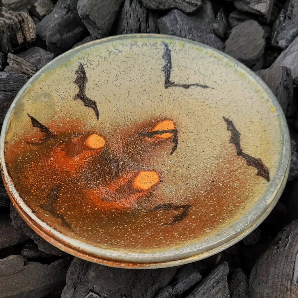 A soda fired plate with bats