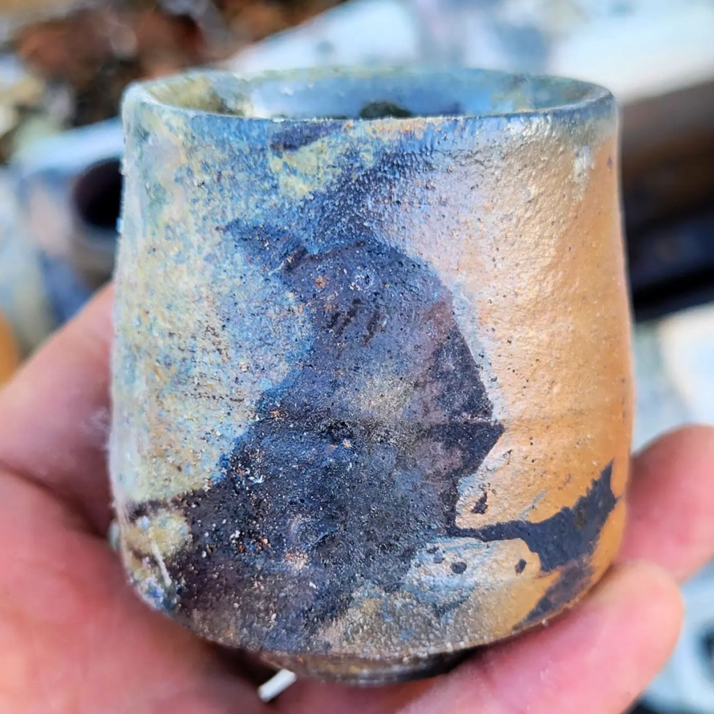 A soda fired cup with bird design