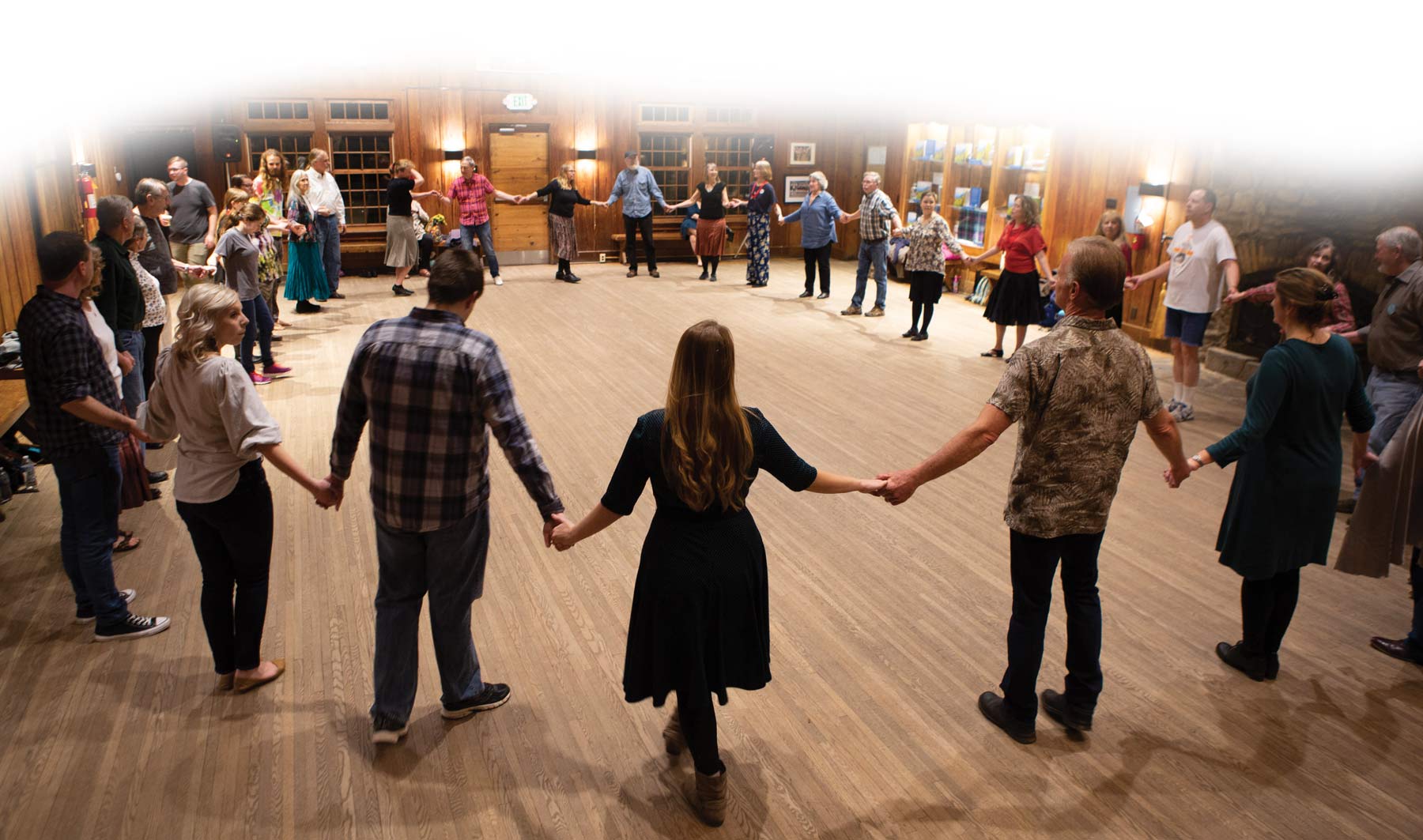 A group of dancers holding hands in a circle.