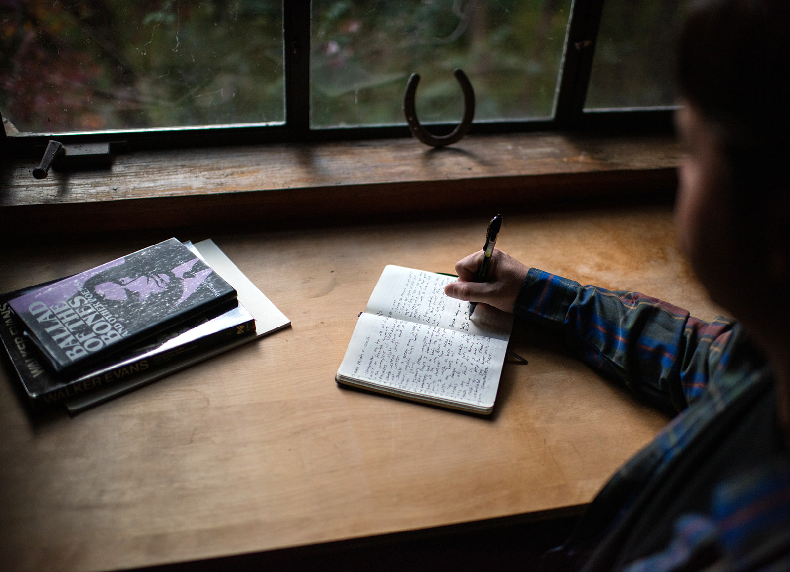 Robert writing. Photo by Cory Marie Podielski Photography