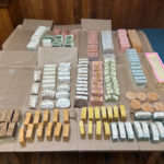 Bars of soap arranged on a table. Over 150 bars in different colors and shapes are on display.