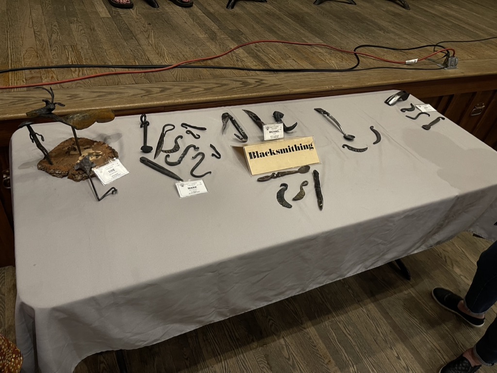 A table displaying student work made in the Blacksmithing class. Objects are in different sections, divided by student.