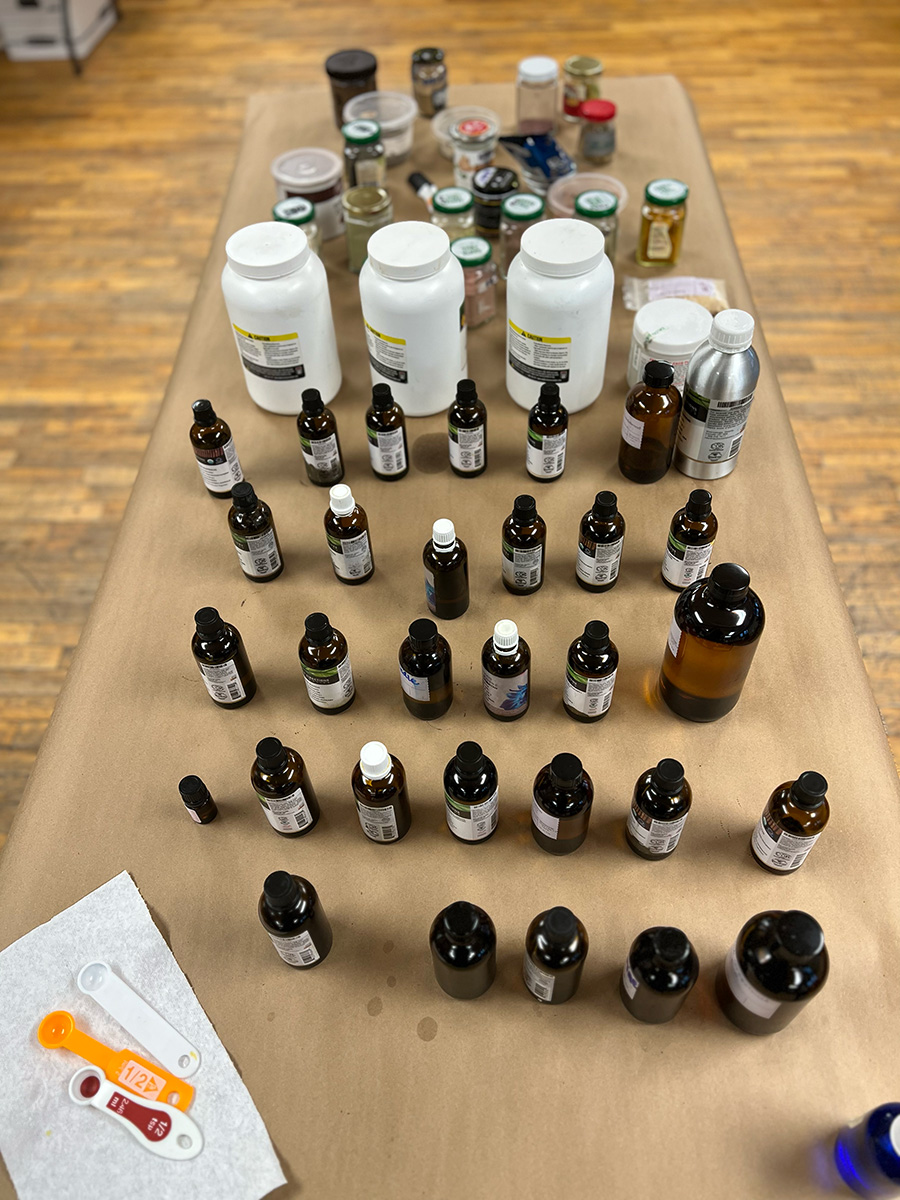 A table with over 25 little jars of essential oils