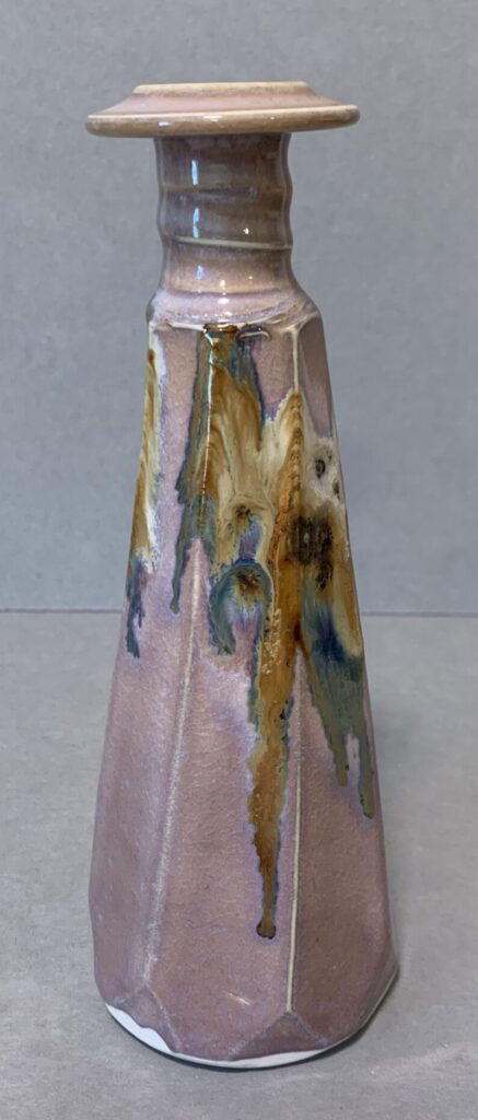 pink glazed ceramic vase, round base with polyhedral sides and marbled design