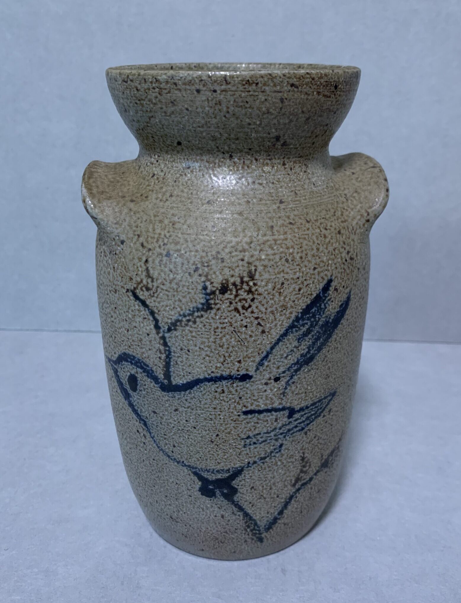 gray glazed ceramic crock with blue slip design of a bird on front