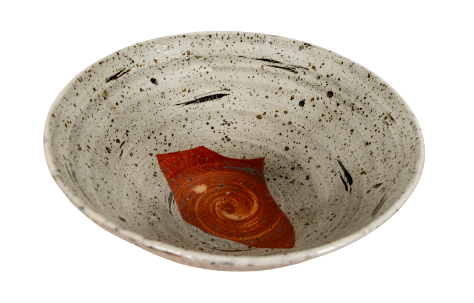 mottled gray and black ceramic bowl with rust-red geometric design in center