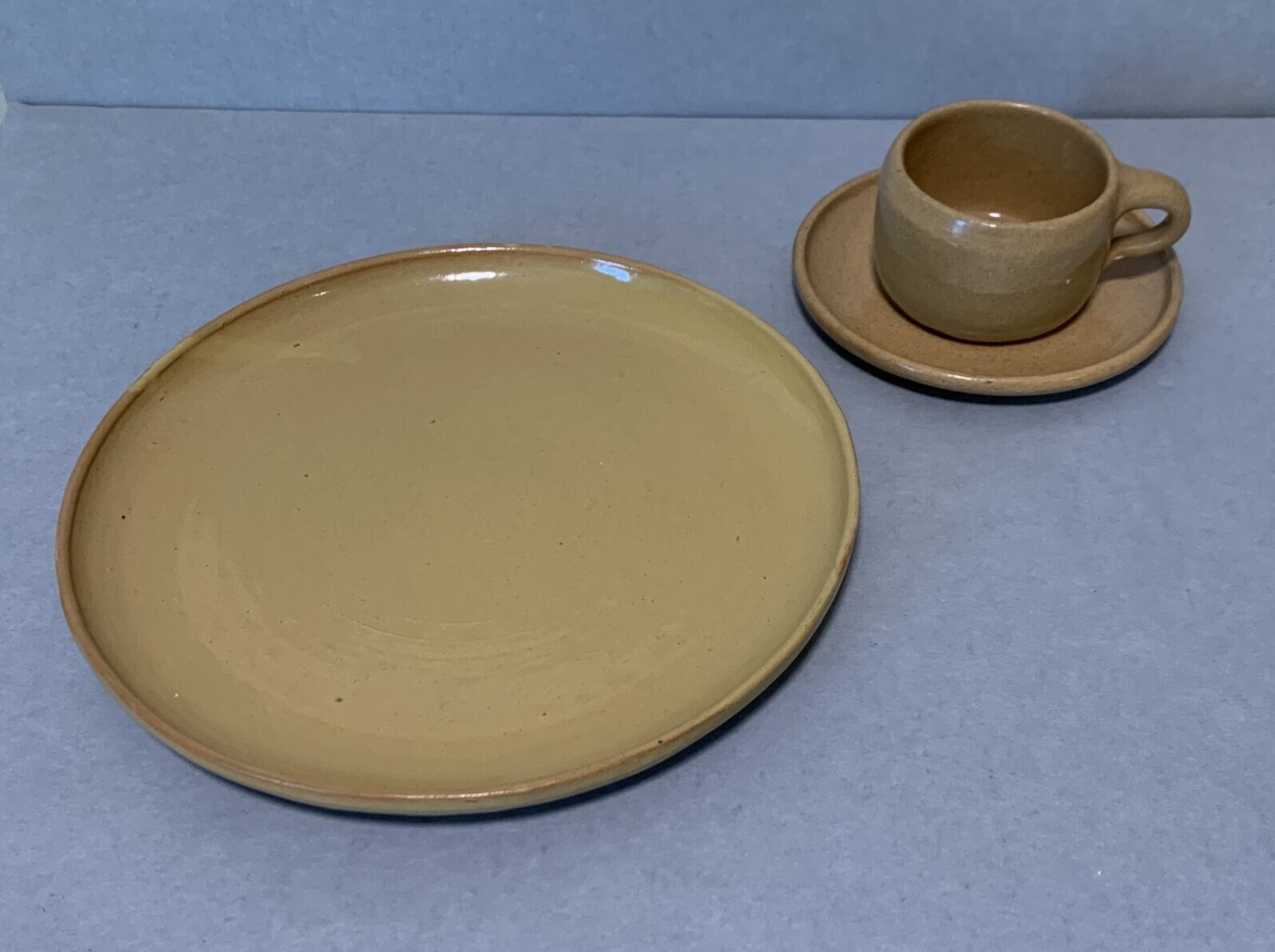 yellow glazed ceramic plate, saucer, and mug